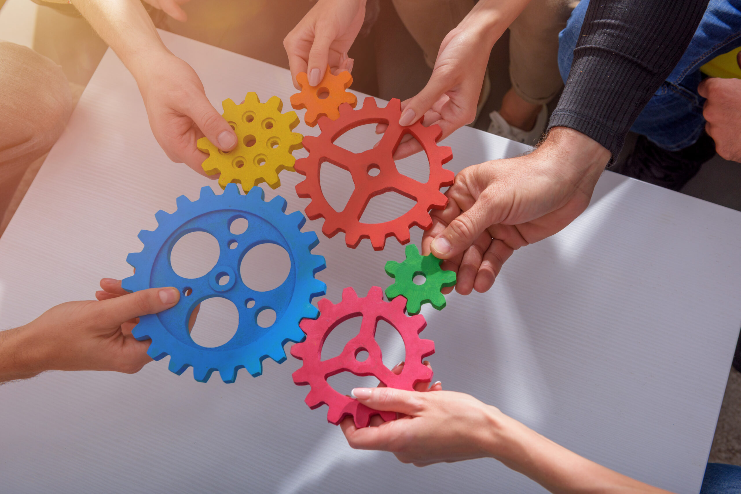 Business people connect pieces of gears like a teamwork and partners