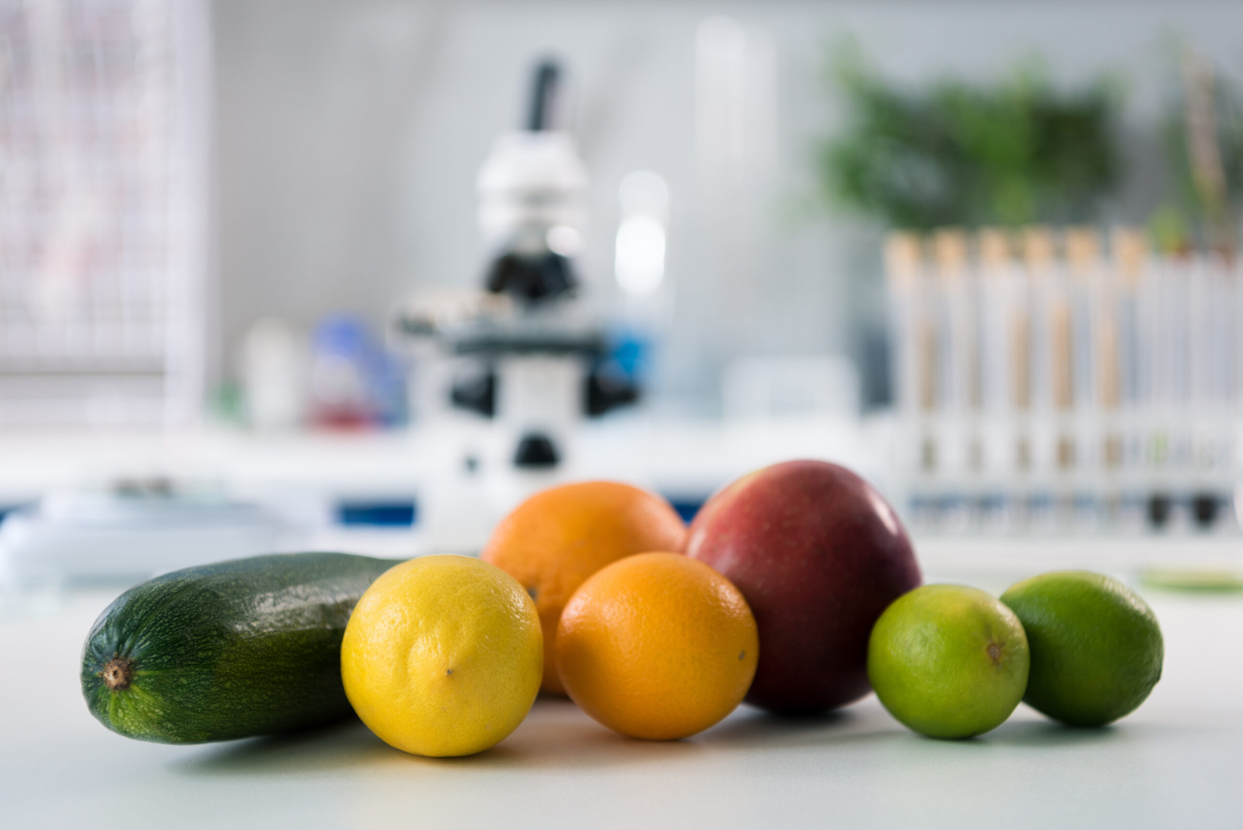 Scientific tools and fruits at workplace in modern biological laboratory